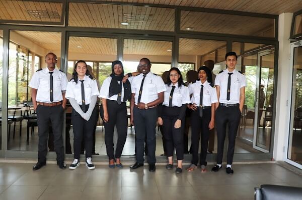 Alpha Aviation Flying School Students pose for a picture outside lecture room