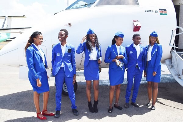 Nairobi Aviation College aviation students besides a plane
