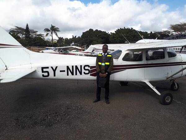 Ninety Nines Flying School Student next to a plane