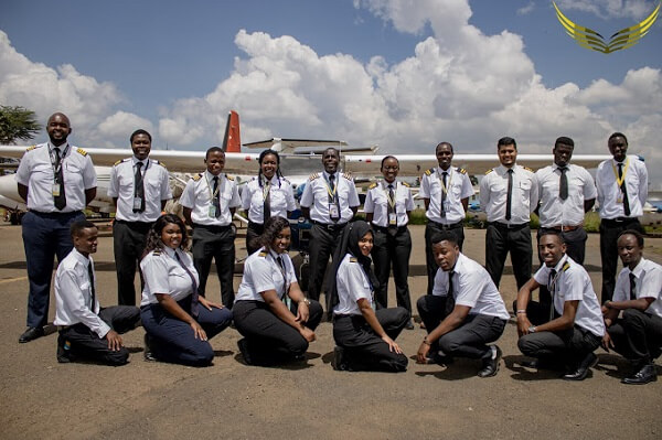 Westrift Aviation Students pose for a group photo in front of a plane