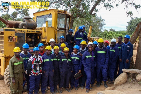 Kilimambogo Highways Building and Technology students pose for photo with an excavator 